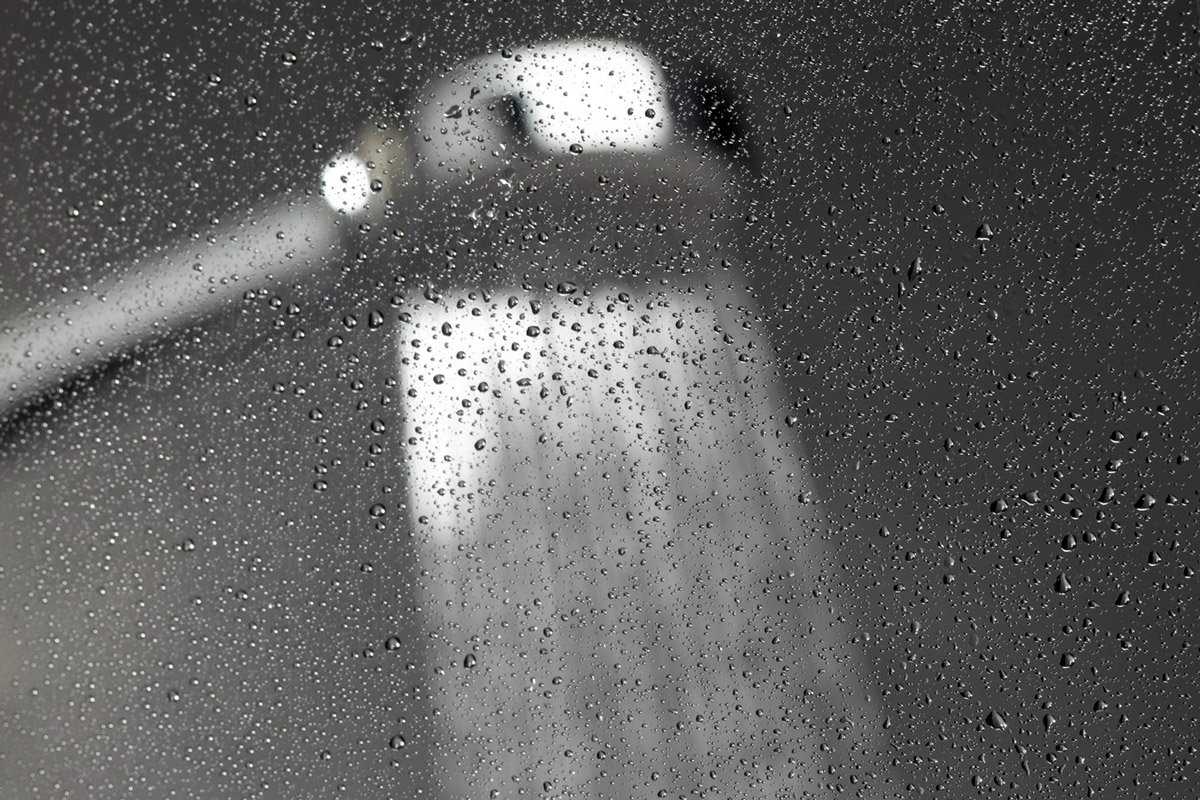 A black and white photo of a shower head.